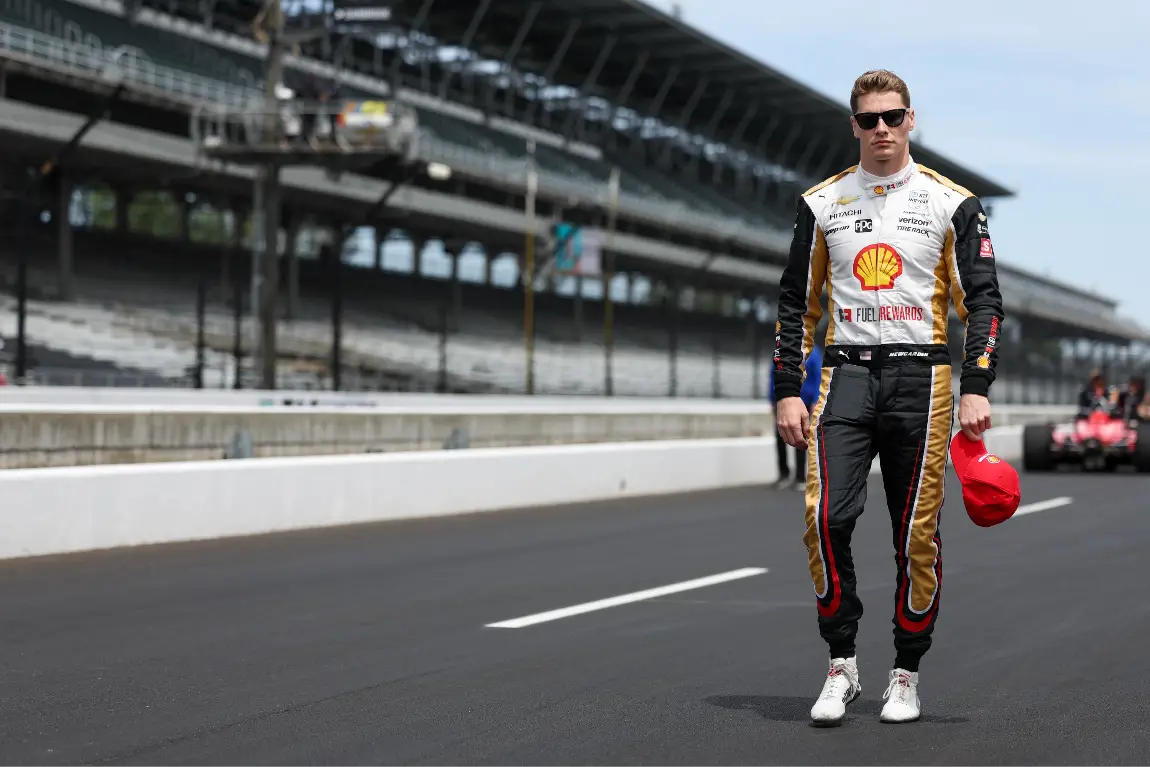 Josef Newgarden walks down pit-road at the Indianapolis Motor Speedway.