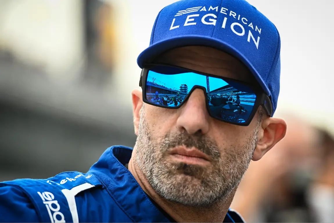 Tony Kanaan stands on pit-road at the Indianapolis Motor Speedway.