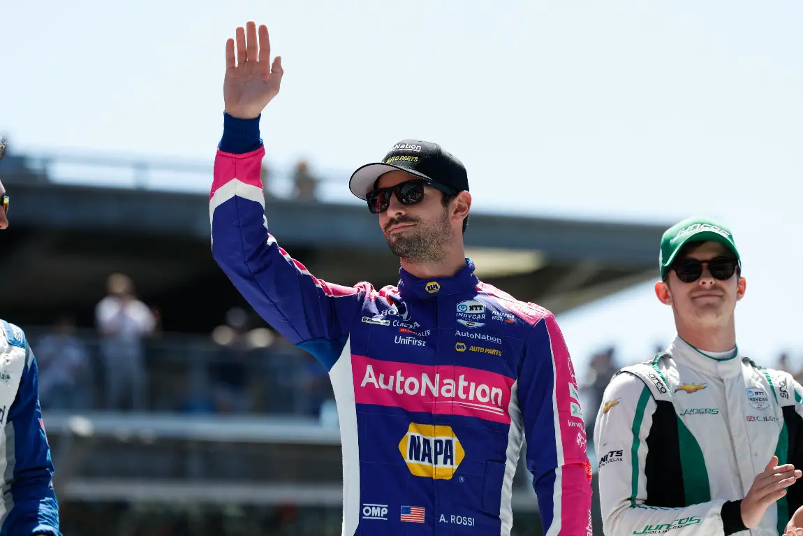 Alexander Rossi waves to the crowd at the Indianapolis Motor Speedway.