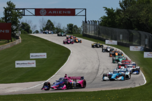 Alexander Rossi leads the NTT IndyCar Series field into turn three at Road America.
