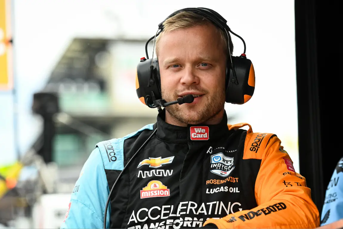 Felix Rosenqvist stands at his team pit-box at the Indianapolis Motor Speedway.