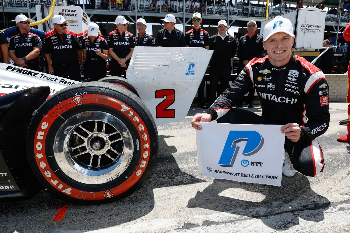 Josef Newgarden poses with the NTT P1 Award after winning the Detroit Grand Prix pole.