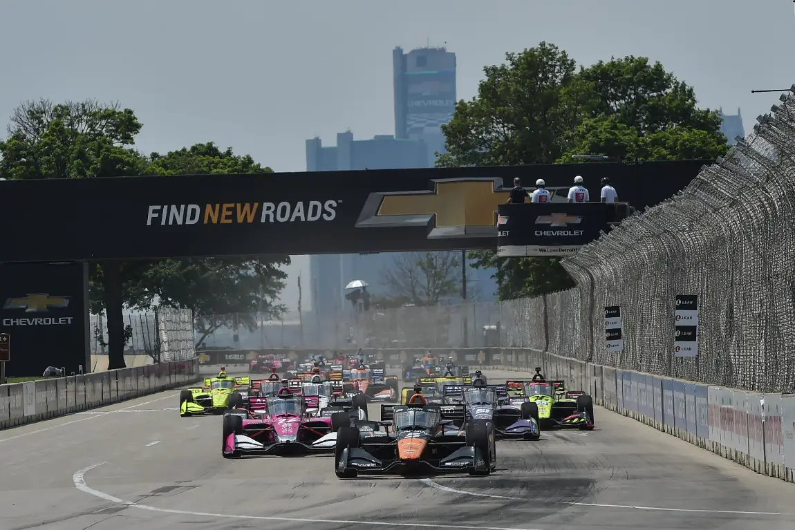 Pato O'Ward leads the 2021 NTT IndyCar Series field down to Turn 1 at the Chevrolet Detroit Grand Prix.