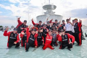Will Power celebrates with his No. 12 Team Penske Chevrolet crew after winning the Detroit Grand Prix in the Scott Fountain.