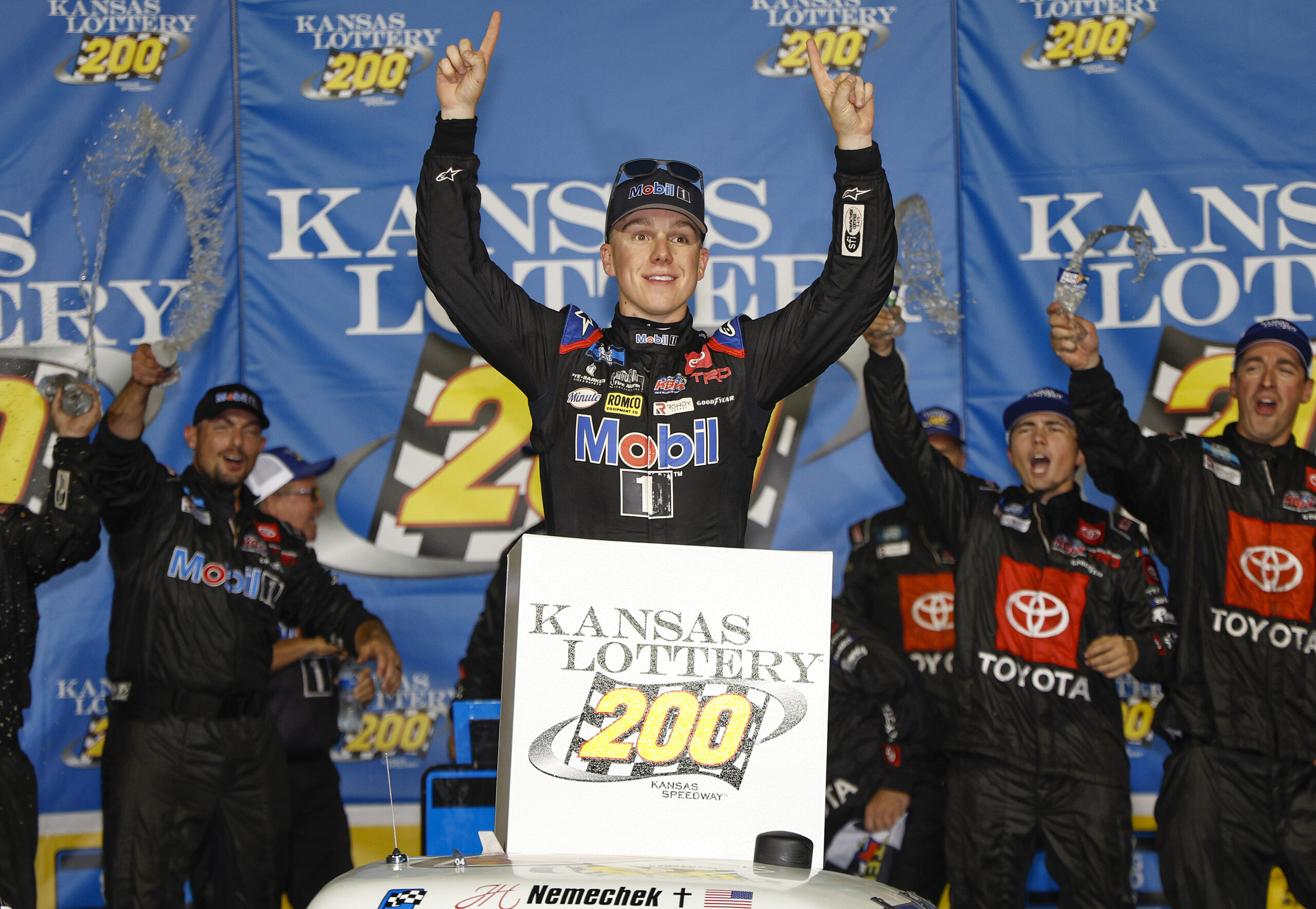 John Hunter Nemechek stands victorious in victory lane after winning the NASCAR Camping World Truck Series race at the Kansas Speedway.