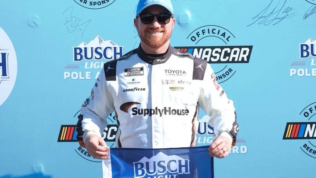 Tyler Reddick celebrates his third pole position of the season after turning the fastest lap in qualifying for the AdventHealth 400 at Kansas Speedway.