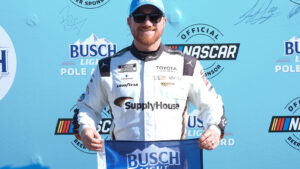 Tyler Reddick celebrates his third pole position of the season after turning the fastest lap in qualifying for the AdventHealth 400 at Kansas Speedway.