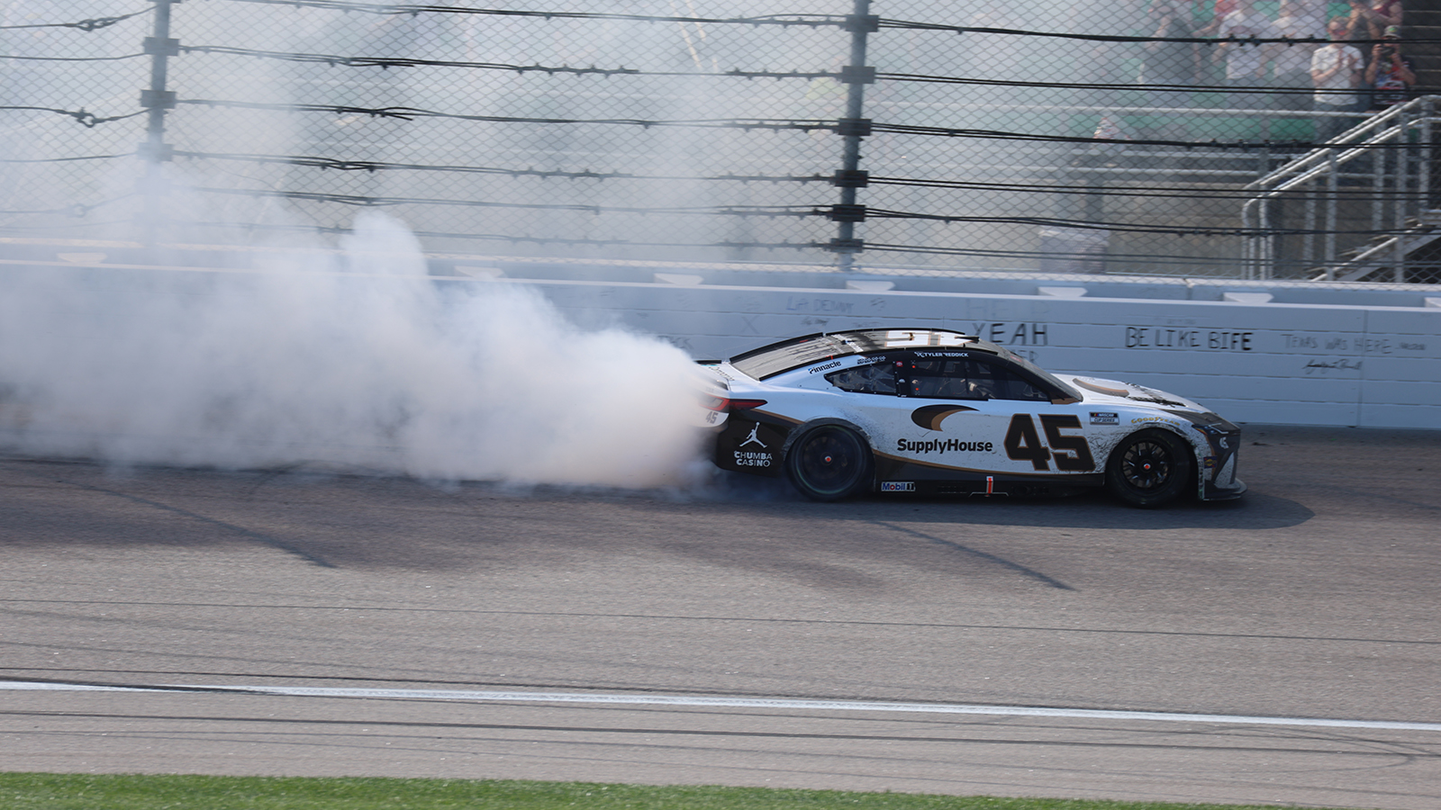 Tyler Reddick performs a burnout after winning the AdventHealth 400 at Kansas Speedway.