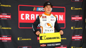 Jake Garcia holds the pole award flag after winning the pole for the NASCAR Craftsman Truck Series Black's Tire 200 at Rockingham Speedway.