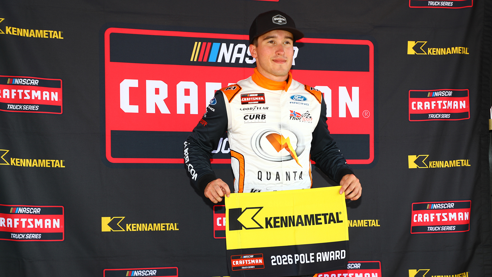 Jake Garcia holds the pole award flag after winning the pole for the NASCAR Craftsman Truck Series Black's Tire 200 at Rockingham Speedway.