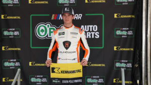 William Sawalich poses with the pole award flag at Bristol Motor Speedway.