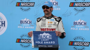 Ryan Blaney poses with the Busch Pole Award flag after winning the pole for the Food City 500 at Bristol Motor Speedway.