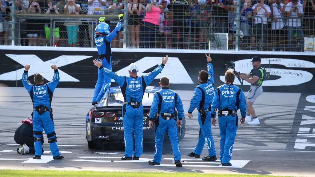Chase Elliott celebrates with his team in front of the crowd after winning the Wurth 400 at Texas Motor Speedway.