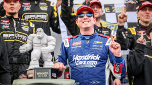 Kyle Busch poses with his trophy in victory lane after winning the ECOSAVE 200 NASCAR Craftsman Truck Series race at Dover Motor Speedway.