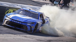 Denny Hamlin performs a celebratory burnout after winning the 2026 NASCAR All-Star Race at Dover Motor Speedway.