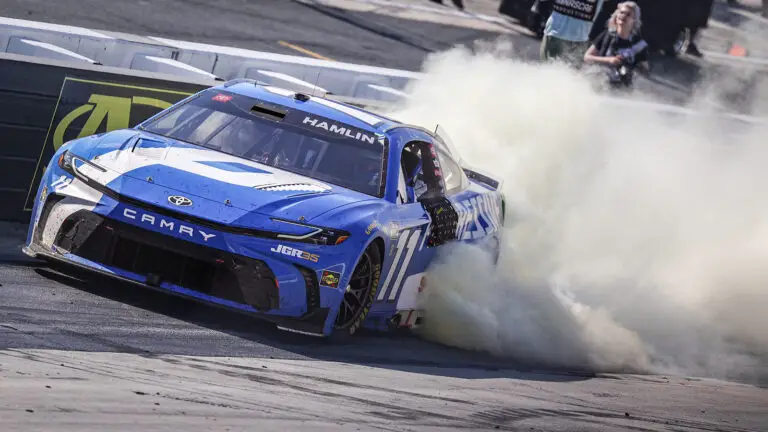 Denny Hamlin performs a celebratory burnout after winning the 2026 NASCAR All-Star Race at Dover Motor Speedway.