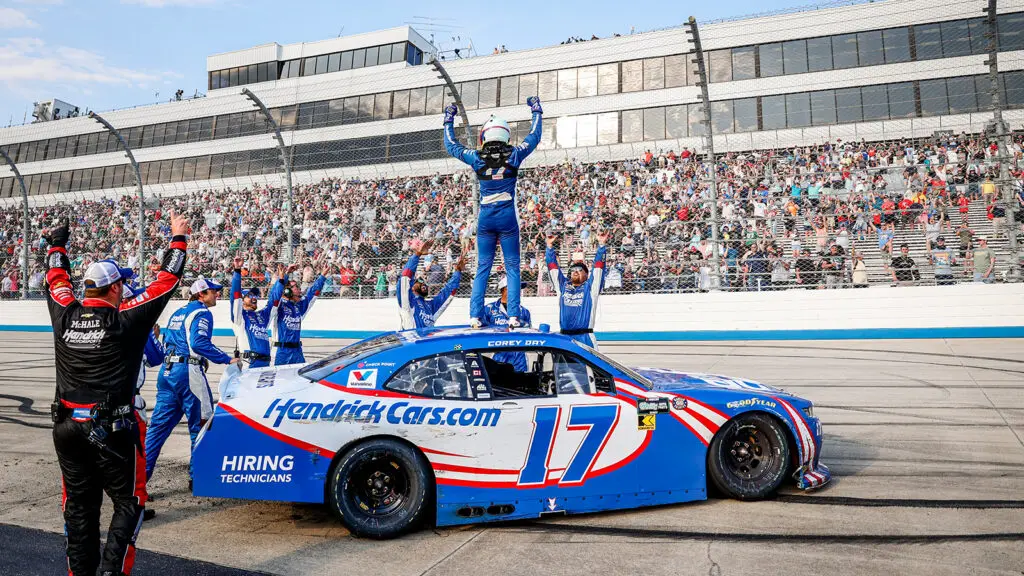Corey Day celebrates with his Hendrick Motorsports team after a win in the BetRivers 200 at Dover Motor Speedway.