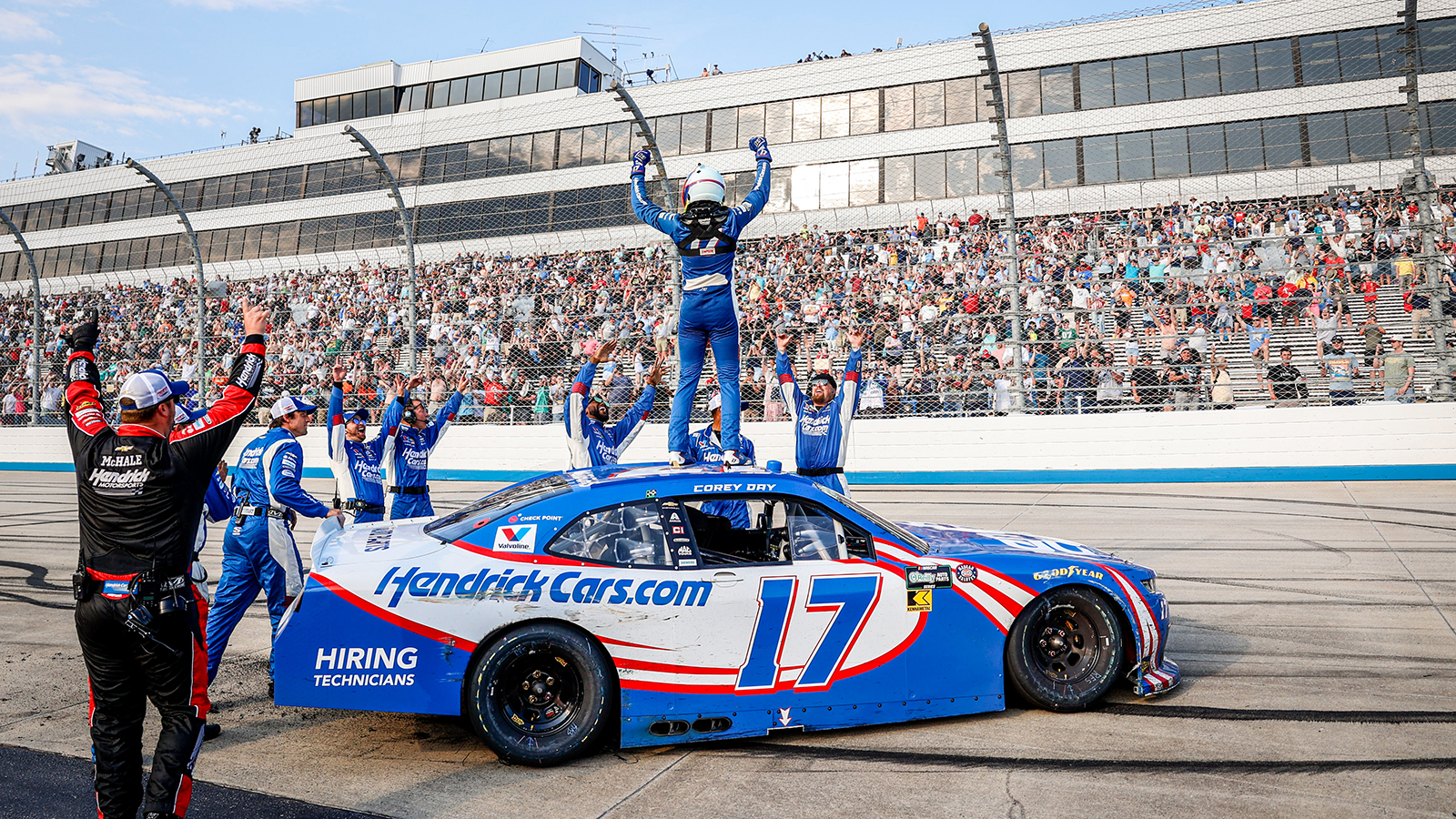 Corey Day celebrates with his Hendrick Motorsports team after a win in the BetRivers 200 at Dover Motor Speedway.
