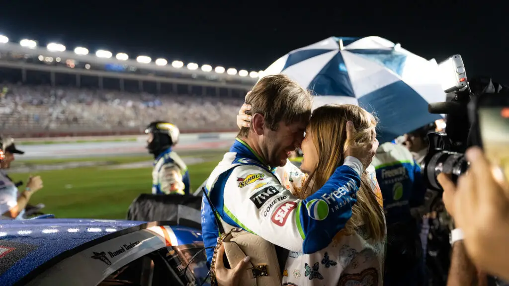 Daniel Suarez embraces his wife Julia following a rain-shortened win in the 2026 Coca-Cola 600 at Charlotte Motor Speedway.