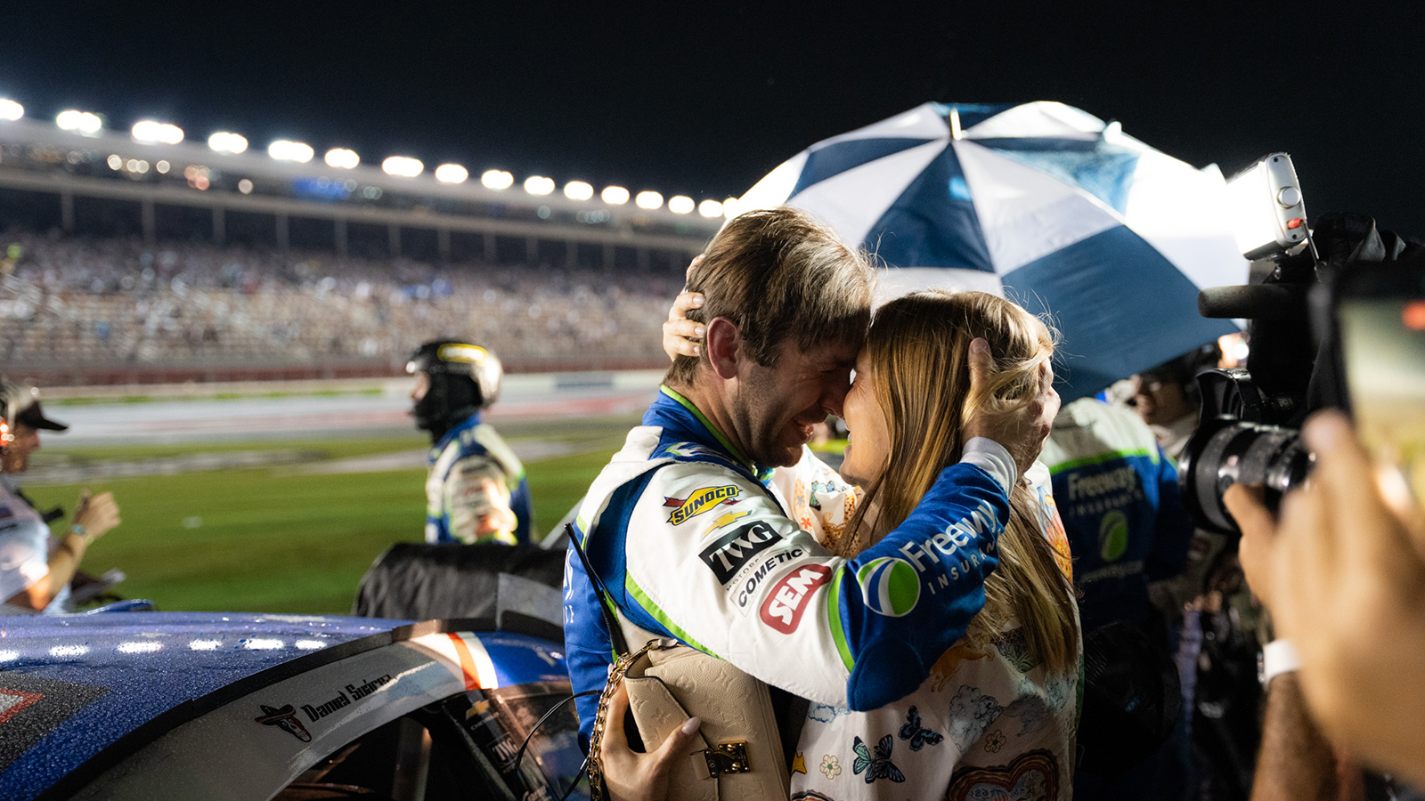 Daniel Suarez embraces his wife Julia following a rain-shortened win in the 2026 Coca-Cola 600 at Charlotte Motor Speedway.
