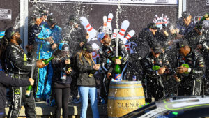 Shane van Gisbergen celebrates with his team in victory lane after a win in the Go Bowling at The Glen