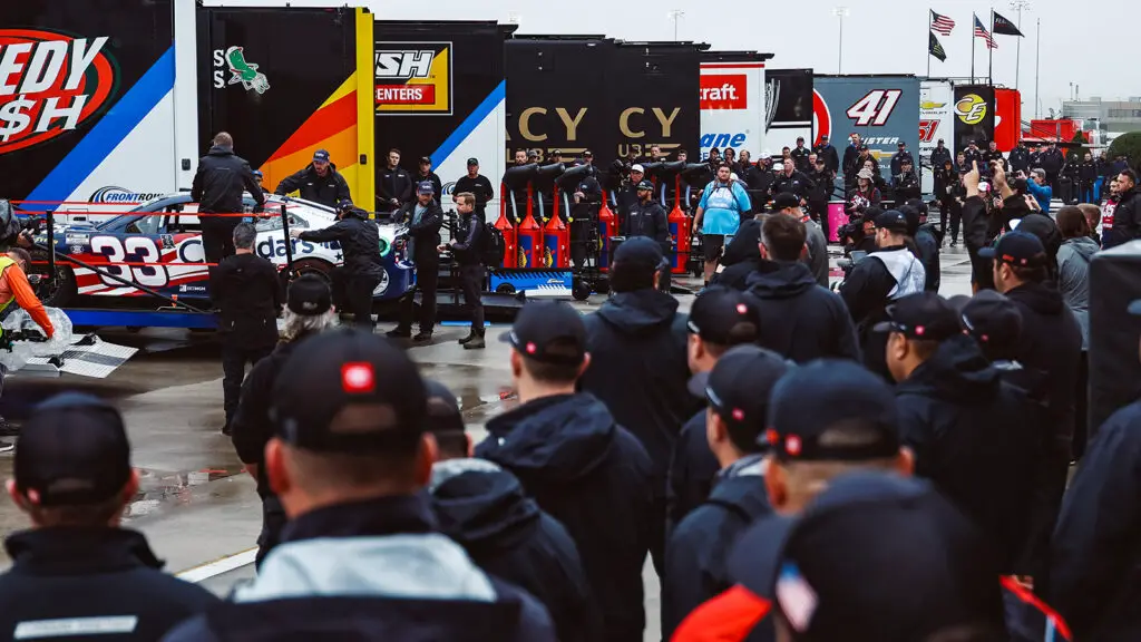 The NASCAR Cup Series garage watches on as the No. 33 Richard Childress Racing team unloads its car at Charlotte Motor Speedway.
