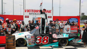 Chandler Smith celebrates a win in the Faith Fest 250 at North Wilkesboro Speedway.