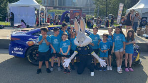 The Boys and Girls Club of North Central Illinois poses with Bugs Bunny and the No. 23 Space Jam Toyota.