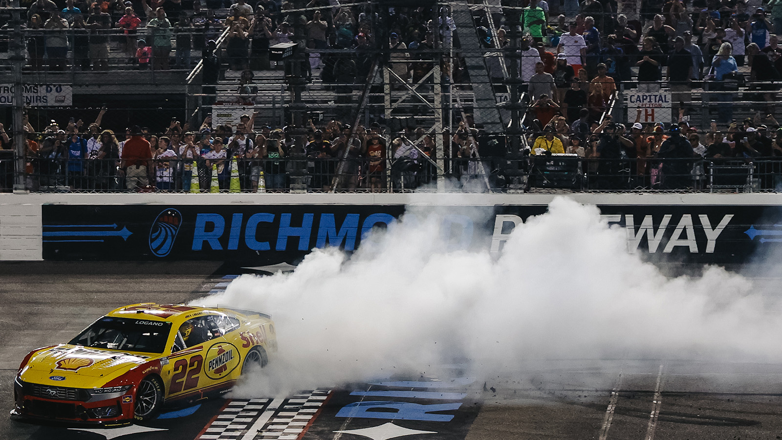 Joey Logano celebrates a win in the Cook Out 400 at Richmond Raceway