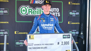 Corey Day poses with an oversized pole award check after winning the pole for the Focused Health 302 at Las Vegas Motor Speedway.